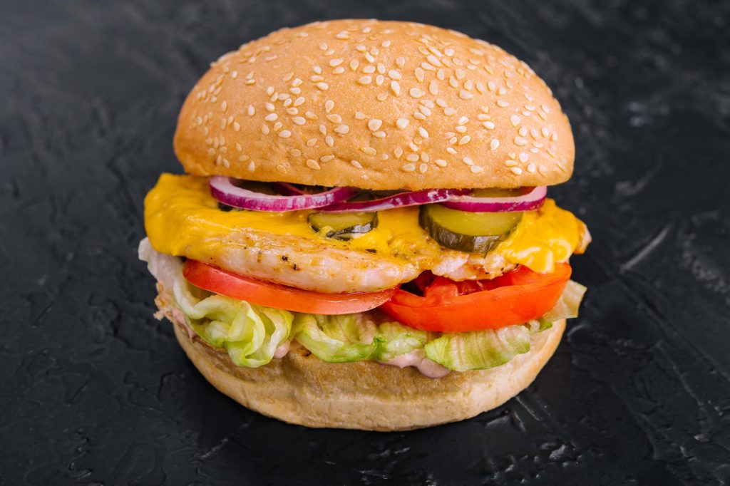 Chicken burger on black stone table