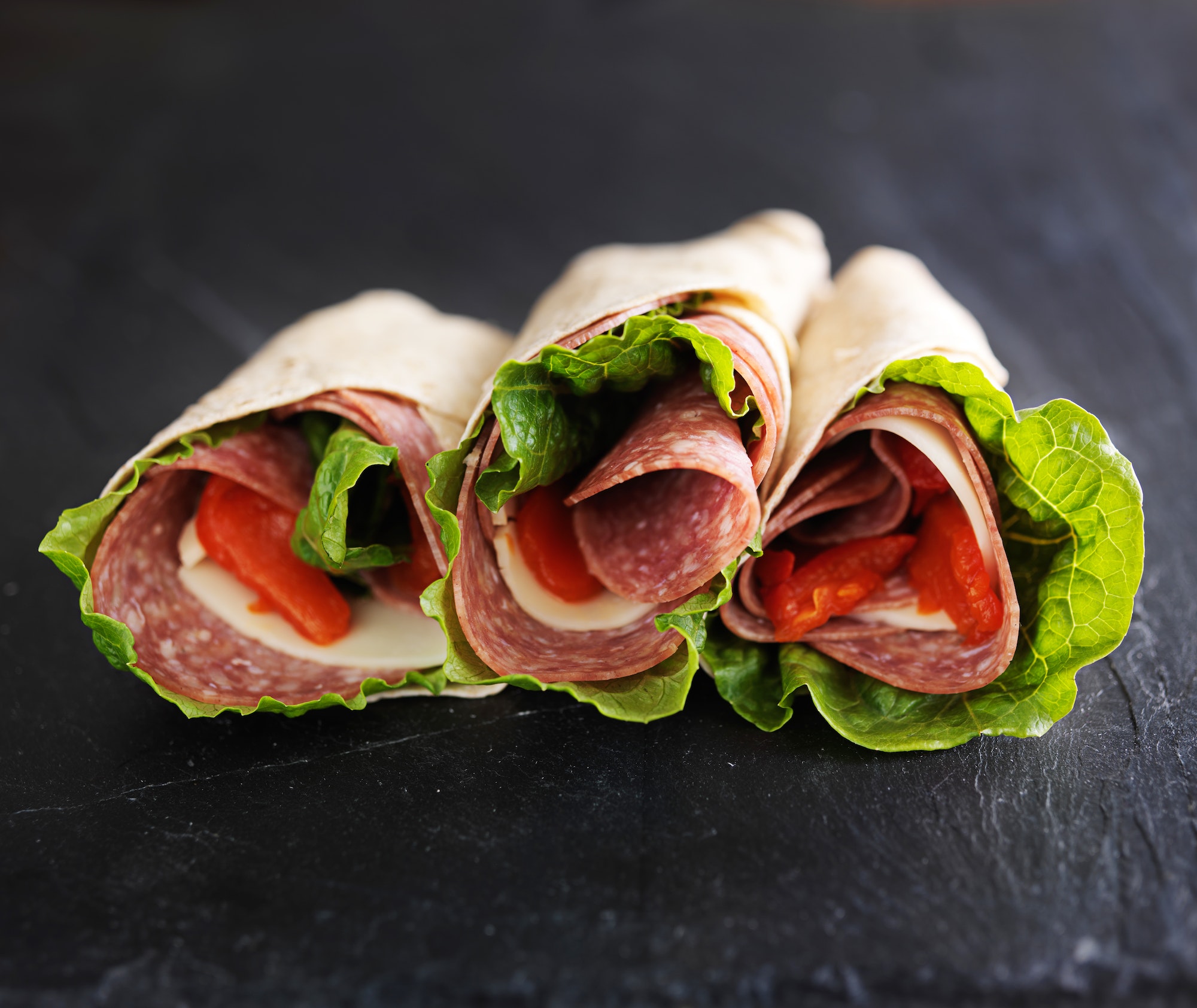 italian wraps with hard salami, lettuce, provolone cheese and roasted pepper